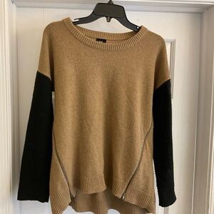 Tan sweater with black sleeves.  Crew Neck, zipper styling.